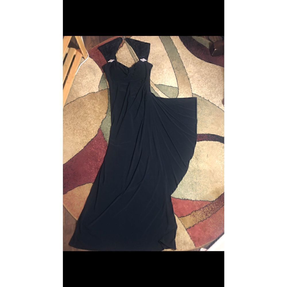 Turn heads with this R & M Richards black cap sleeve beaded gown.Retail $149.00